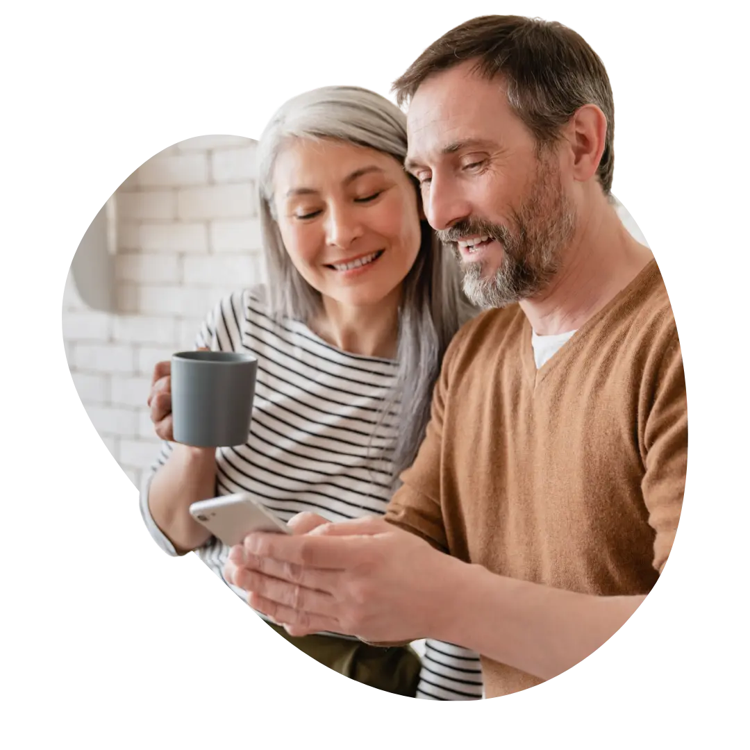Happy couple looking at phone together